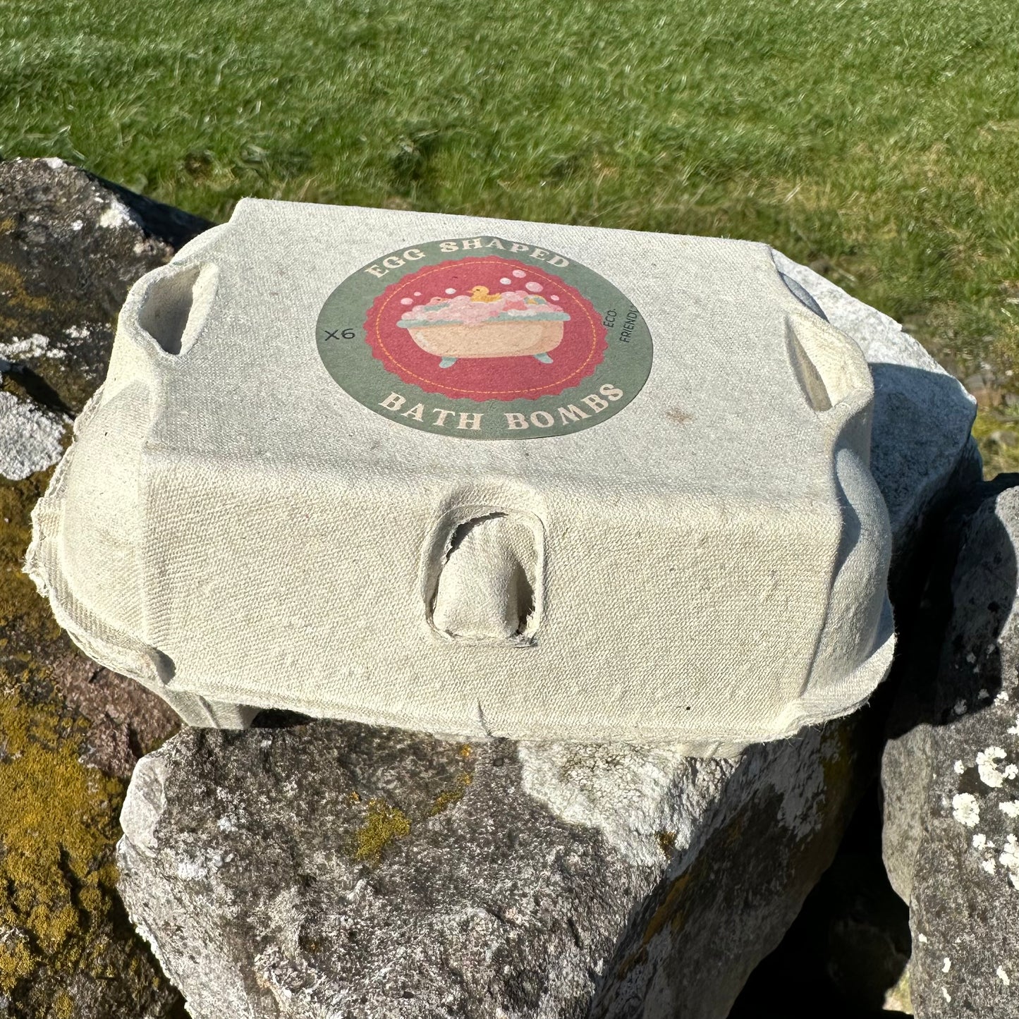 Six egg-shaped bath bombs in an eco-friendly egg box.