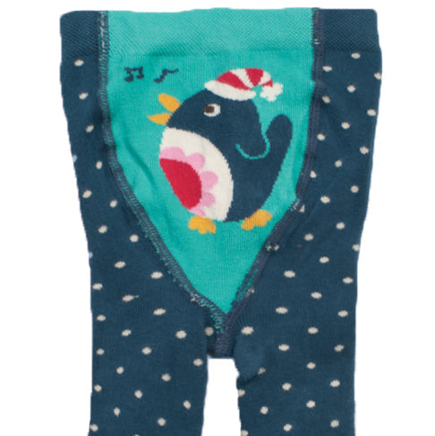 A pair of toddler tights in dark teal blue with small white polka dots, featuring a bright teal bib panel at the top with a cartoon penguin wearing a red and white Santa hat.