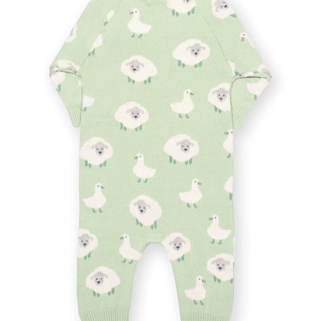 Green baby onesie with white floral and duck pattern on a white background