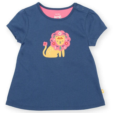 A navy blue short-sleeve baby t-shirt with a colorful cartoon lion graphic on the front, featuring a pink flower crown and a yellow body. The brand name 'k&te' is visible on the inner neck label.