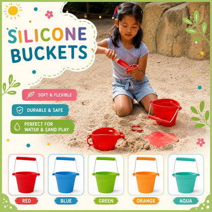 A young girl kneels in sand playing with red silicone buckets and a small shovel, with decorative text reading 'SILICONE BUCKETS' and five color options shown along the bottom: red, blue, green, orange, and aqua.