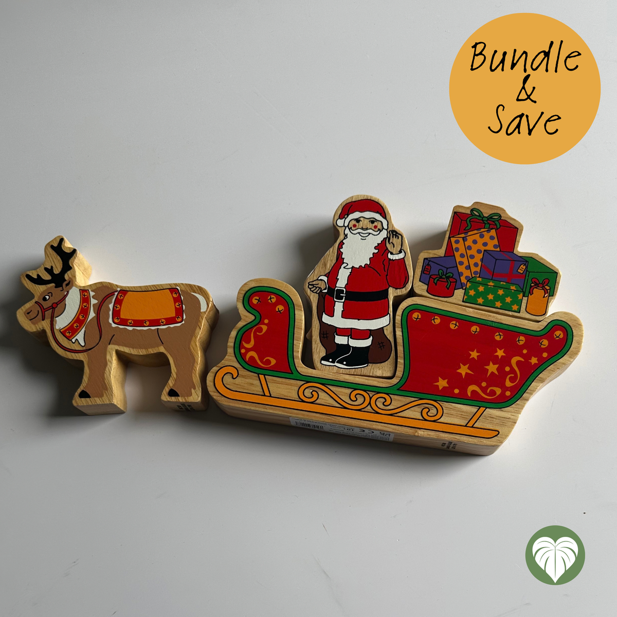 A wooden Christmas toy set featuring a reindeer and a sleigh carrying Santa Claus and presents, photographed on a plain light background with a yellow 'Bundle & Save' badge in the top right.
