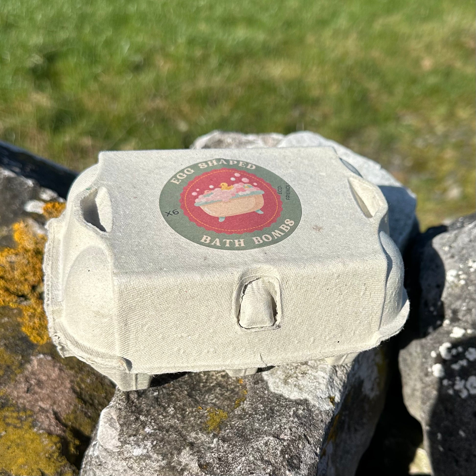 Six egg-shaped bath bombs in an eco-friendly egg box.