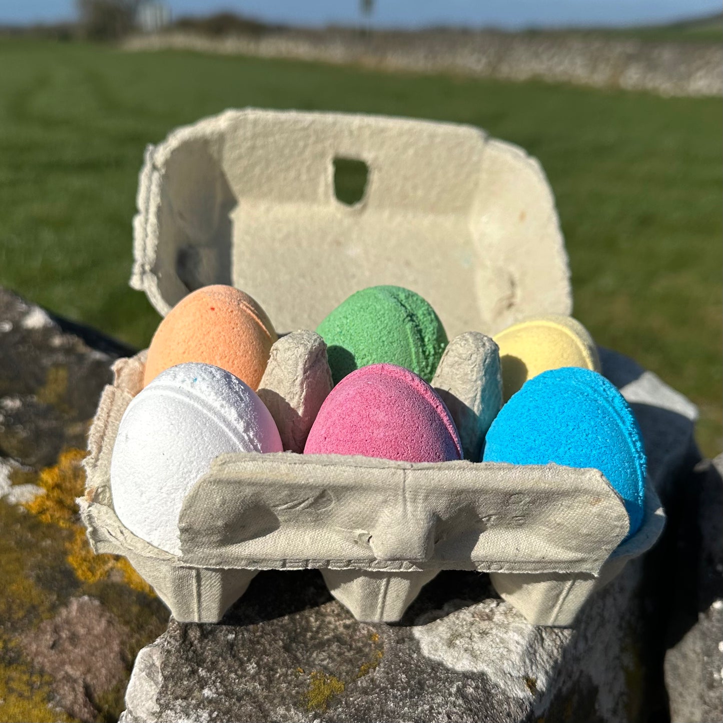 Six egg-shaped bath bombs in an eco-friendly egg box.