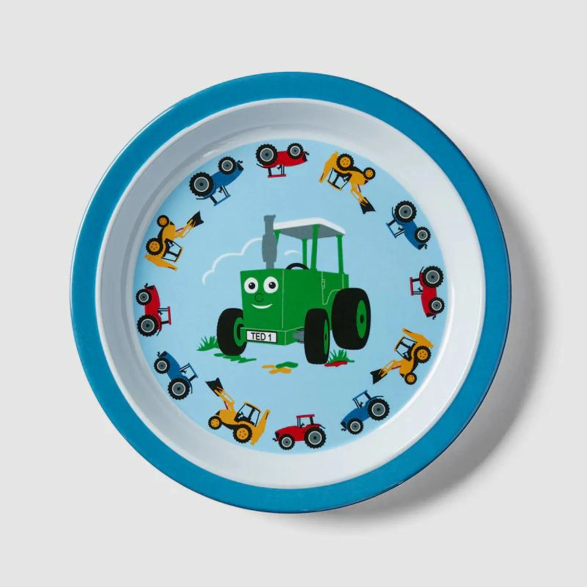 Children's plate with a green tractor and colorful vehicles on a blue rim against a light gray background