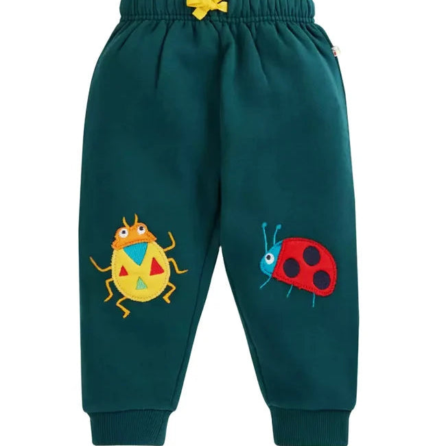 Dark teal green children's sweatpants with a yellow drawstring waist and embroidered cartoon bugs on the legs, shown against a plain white background.