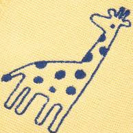 A close-up of a pale yellow textured fabric featuring a navy blue embroidered giraffe design.