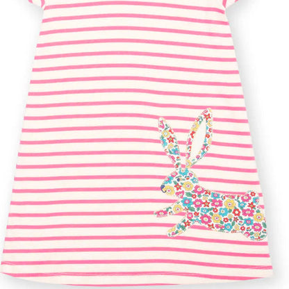 A short-sleeve children's dress with horizontal pink and off-white stripes, featuring a colorful floral-patterned rabbit applique on the lower right side, shown against a plain white background.