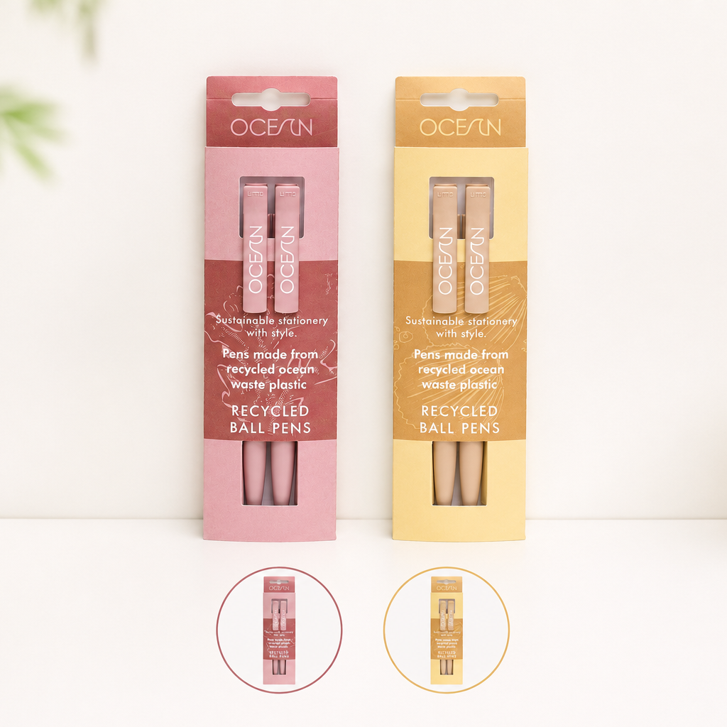 Two Ocean brand recycled ballpoint nail pens in pink and yellow packaging, displayed on a white surface with small circular insets showing the pen tips.