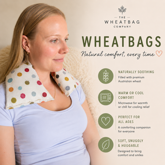 A woman wearing a Wheatbag Company wheatbag neck wrap around her neck, shown in a lifestyle setting with promotional text and icons on a warm beige background.